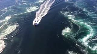 Boat cruising through Saltstraumen maelstrom near Bodø Norway [upl. by Ute]